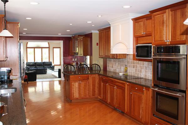 179 Hudson Road Stow, MA 01775 - Photo 4 of 21 a kitchen with stainless steel appliances granite countertop wooden cabinets a sink and a stove