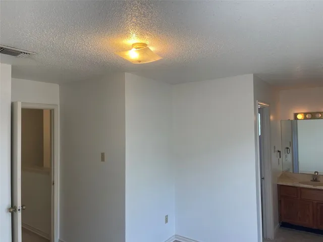 a view of bathroom with a sink and mirror