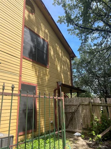 a yellow house with trees in front of it