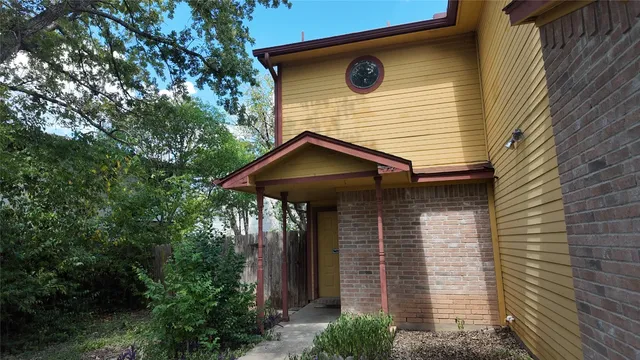 a front view of a house with plants