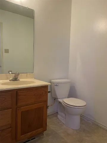 a bathroom with a sink toilet and a mirror