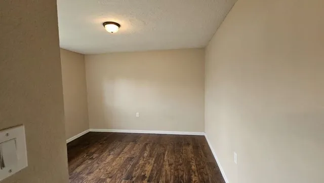 a view of an empty room and wooden floor