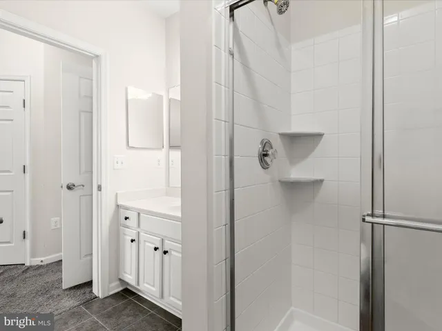 a bedroom with a large bed and a potted plant