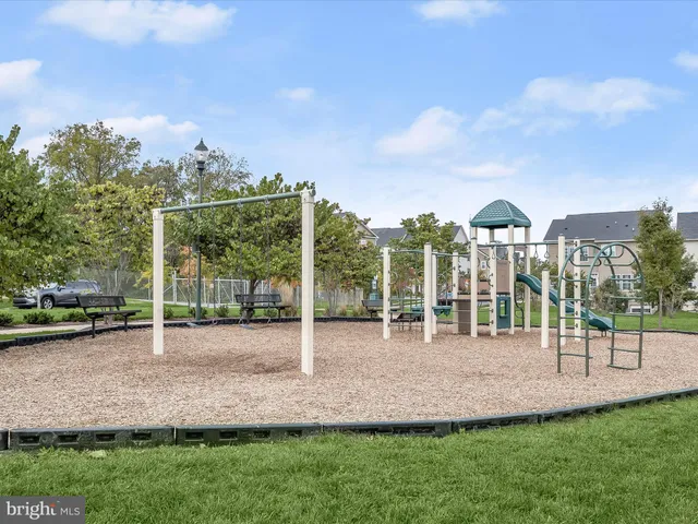 a view of a road with a big yard and plants