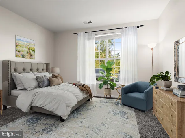 a bedroom with a bed and a couch