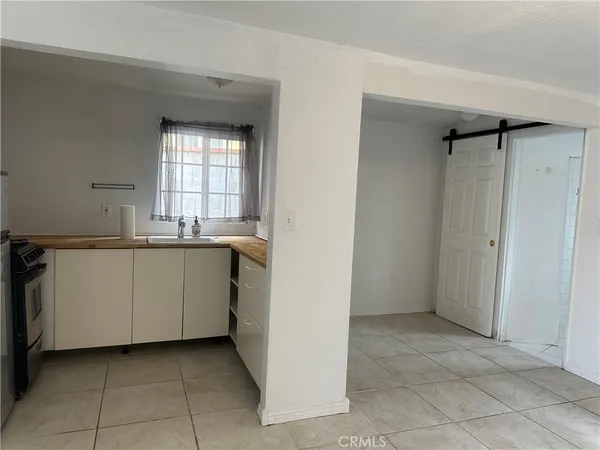 a view of a kitchen with white cabinets