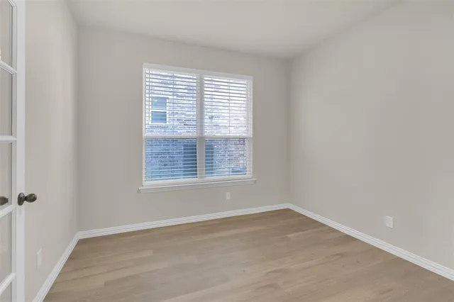 a kitchen with granite countertop a sink and white cabinets