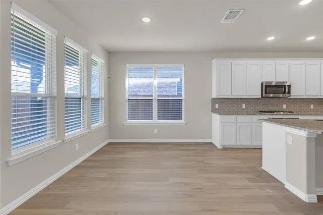 a view of a kitchen with a stove cabinets and wooden floor