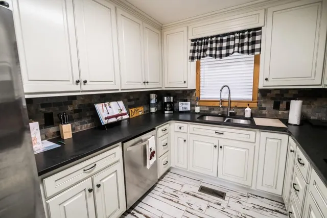 a kitchen with stainless steel appliances granite countertop a sink and cabinets