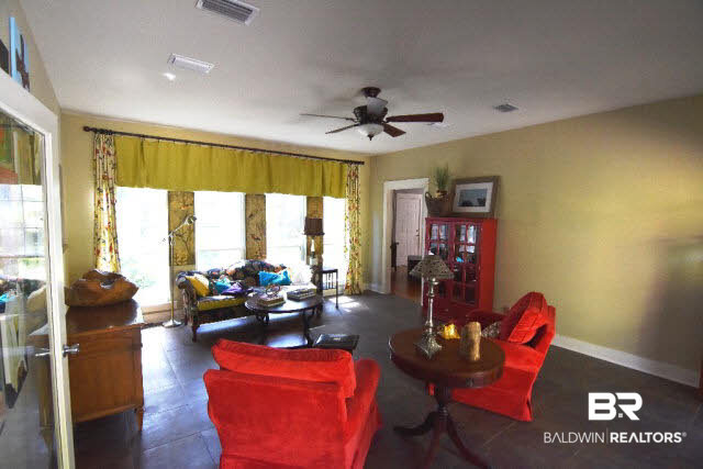 13848 Elmwood Court Stapleton, AL 36578 - Photo 9 of 27 Comfortable and inviting Sun Room has view of the pond and forest. Opens to the back deck and pool area. Guest suite can be accessed from the Sun Room.