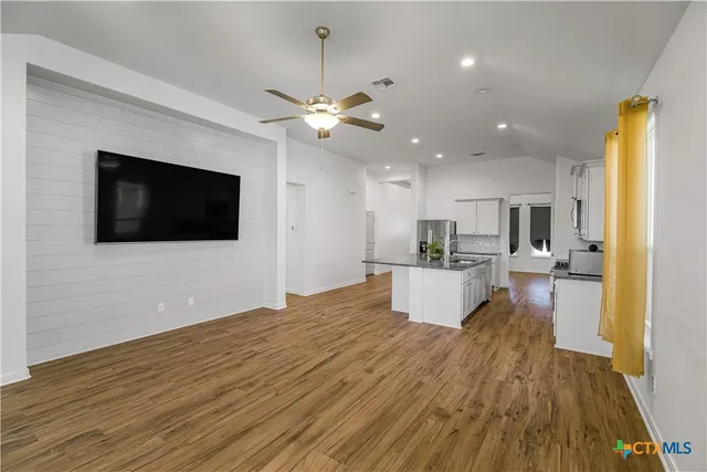 a view of a kitchen with a sink and a microwave
