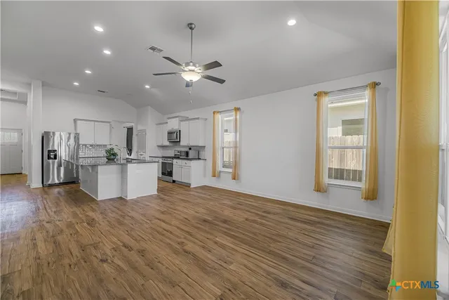 a view of a kitchen with wooden floor and a kitchen