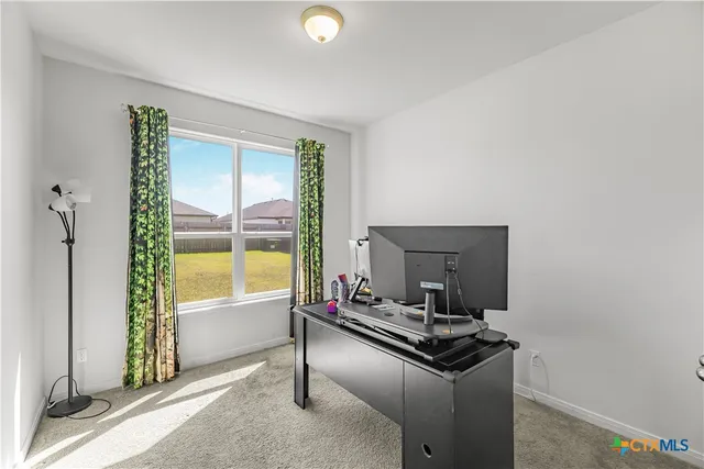 a living room with a bed furniture and a window