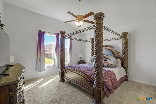 a bedroom with a bed dresser and a window