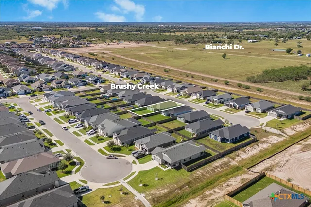 an aerial view of residential building and lake