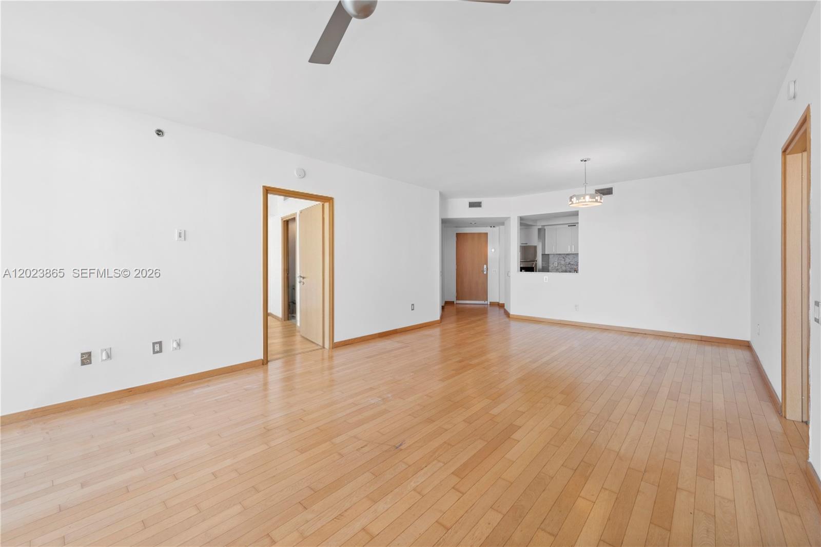 450 Alton Road, Unit 3206 Miami Beach, FL 33139 - Photo 4 of 25 an empty room with wooden floor and windows