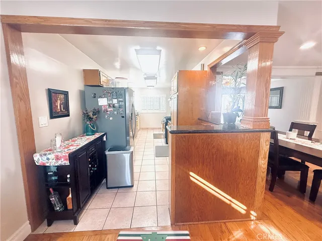 a kitchen with stainless steel appliances granite countertop a refrigerator and a stove