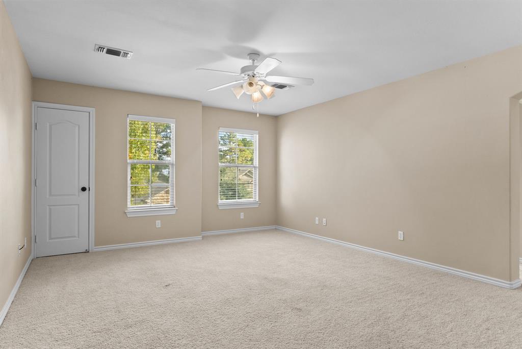 6679 Lacebark Circle Tyler, TX 75703 - Photo 21 of 38 an empty room with windows and ceiling fan