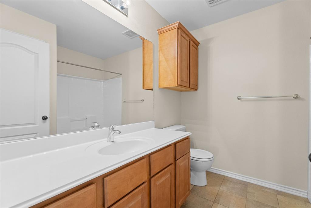6679 Lacebark Circle Tyler, TX 75703 - Photo 27 of 38 a bathroom with a sink a toilet and a mirror