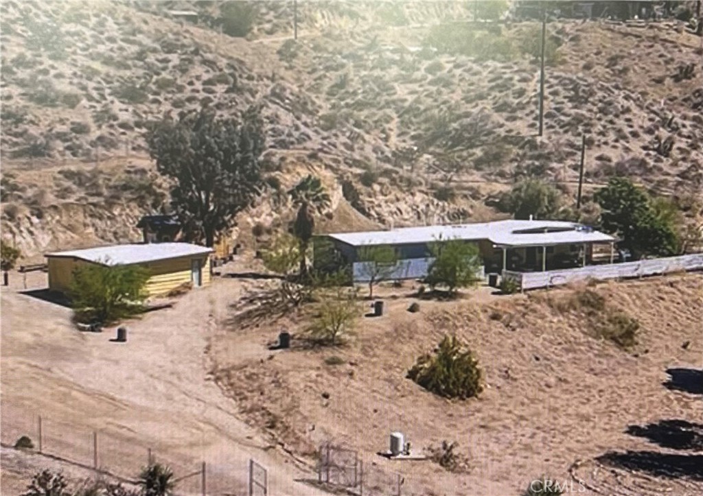 9345 South Samel Road Morongo Valley, CA 92256 - Photo 1 of 1 a view of a dry yard with wooden fence