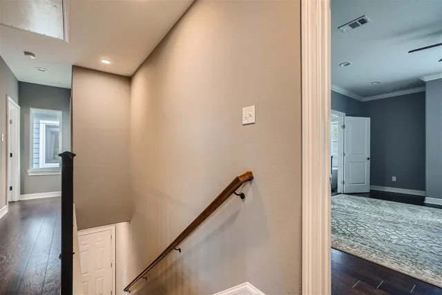 a view of hallway with stairs and a wooden floor