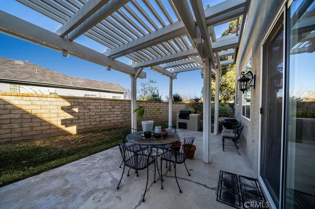 a view of a porch with chairs and potted plants