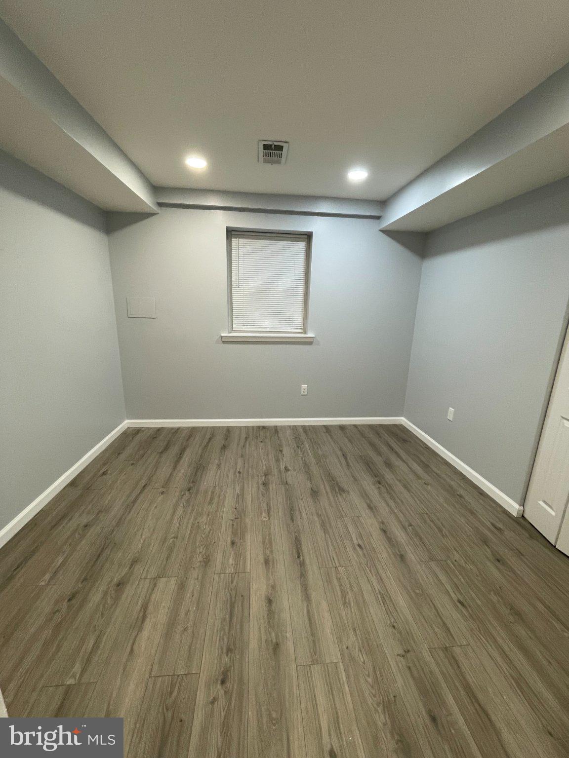 2016 Gatewood Place Silver Spring, MD 20903 - Photo 20 of 24 an empty room with wooden floor and windows