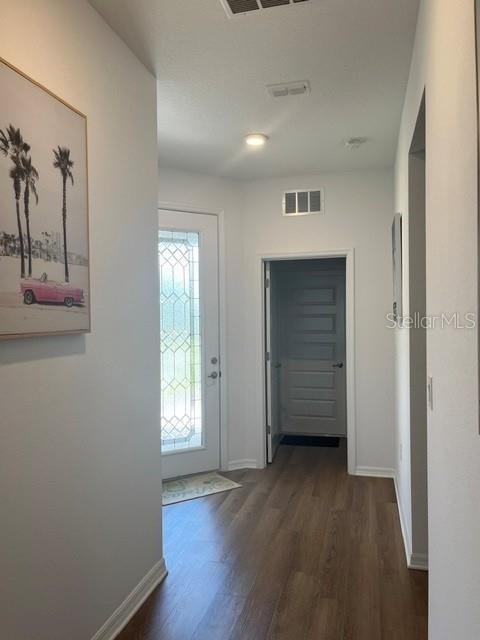 7978 Southwest 90th Terrace Ocala, FL 34481 - Photo 4 of 20 an empty room with wooden floor and windows