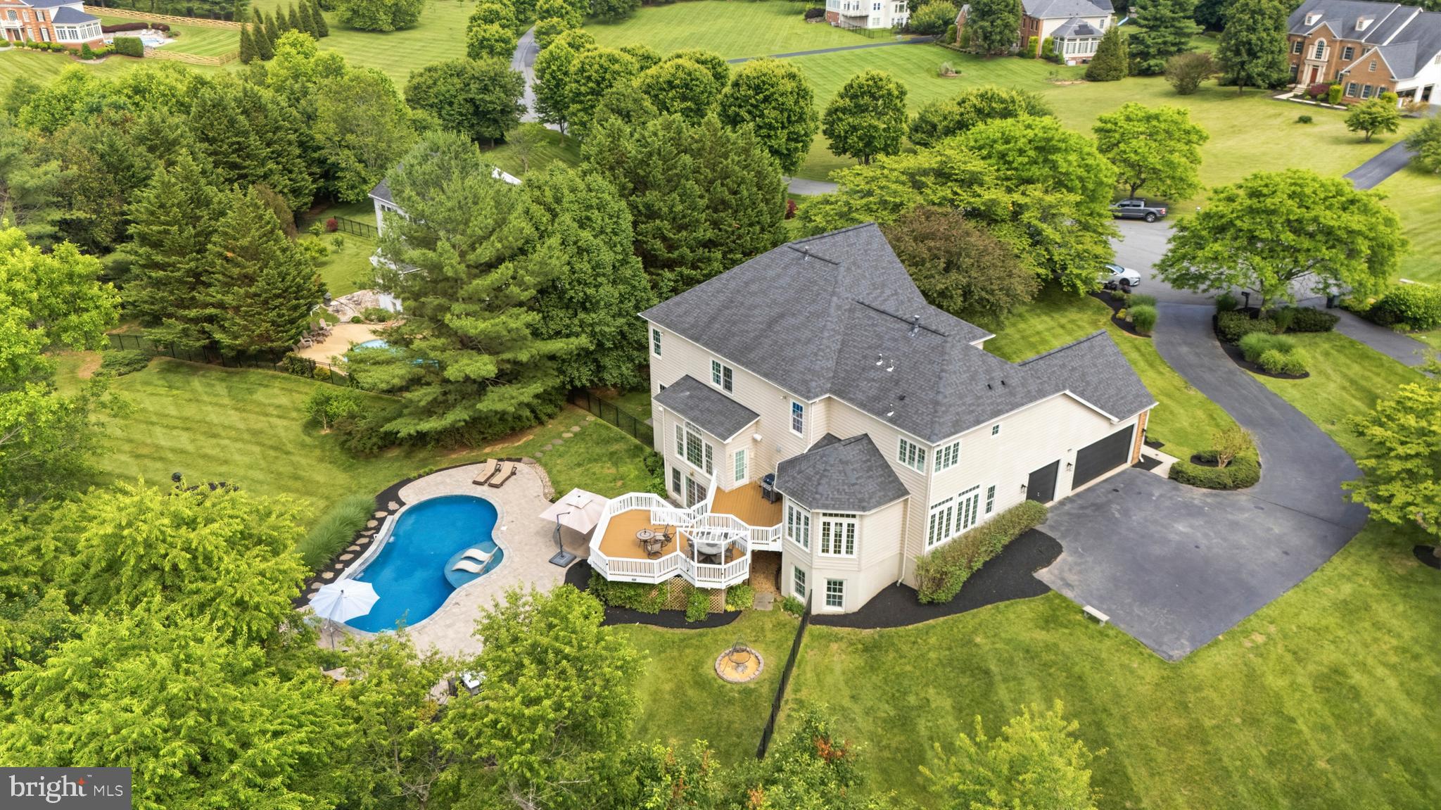 9313 Harrisons Farm Way Laytonsville, MD 20882 - Photo 72 of 77 an aerial view of a house with swimming pool and garden