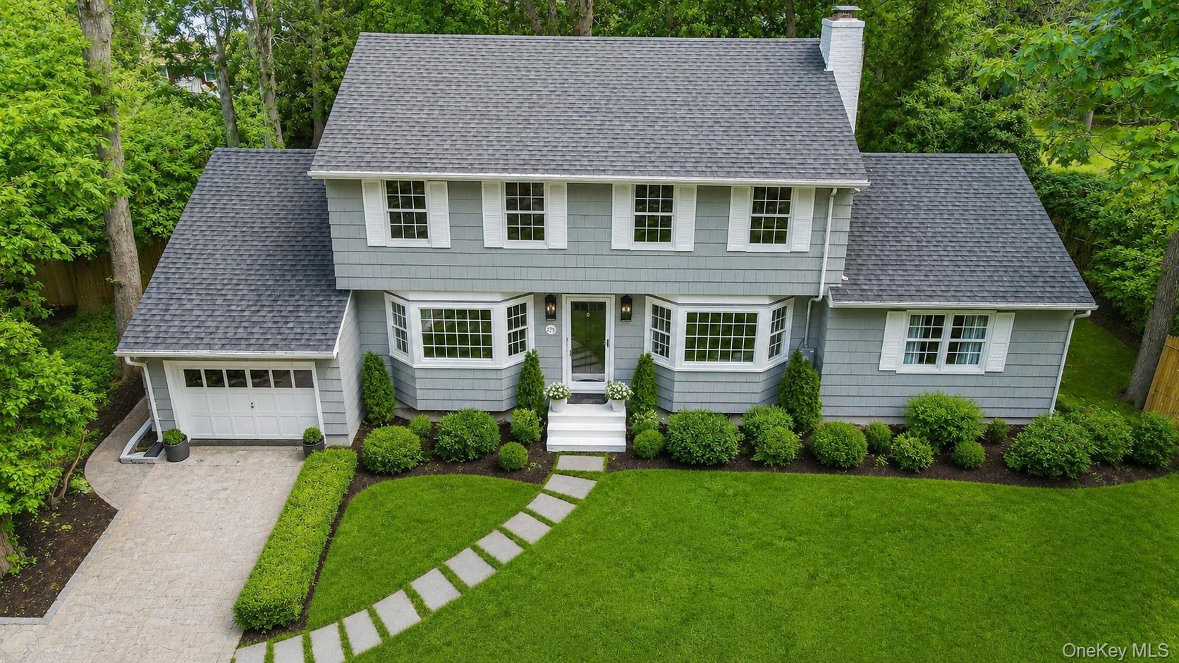 275 Pinewood Road Cutchogue, NY 11935 - Photo 35 of 45 Colonial-style residence featuring a gray shingle exterior, bay windows, and a gray shingle roof
