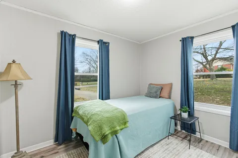 a bedroom with a bed and large window