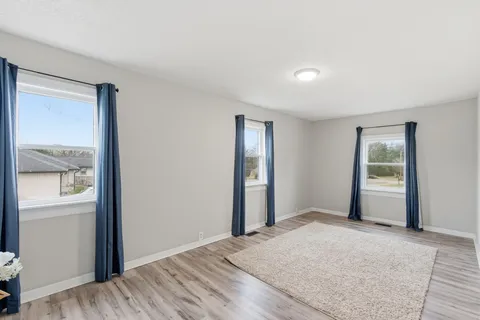 an empty room with windows and closet