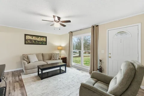 a living room with furniture and a large window
