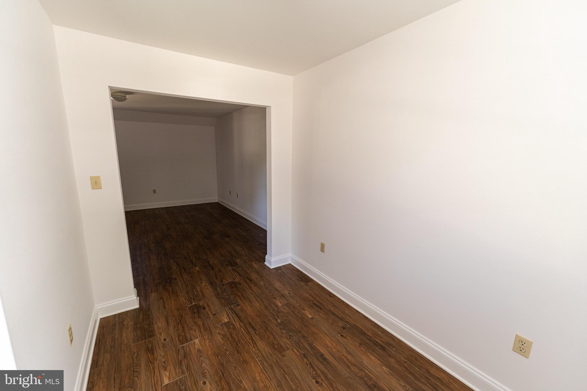 804 Travers Street, Unit 2 Cambridge, MD 21613 - Photo 9 of 26 a view of wooden floor in a room