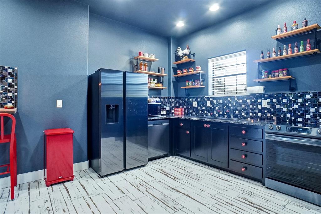 13240 Briar Road Azle, TX 76020 - Photo 29 of 39 a room with lots of wooden cabinets and glass shelves