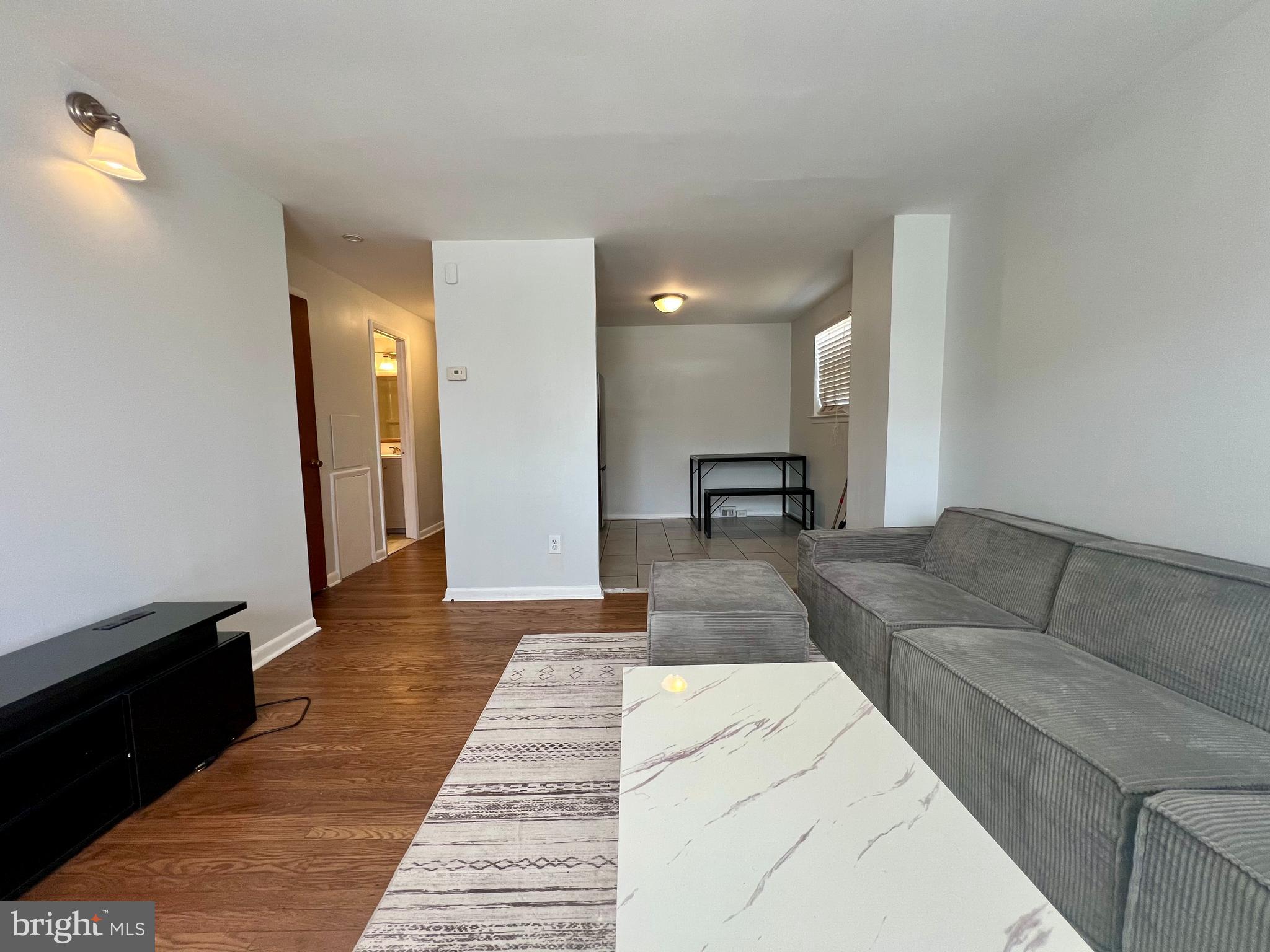 7201 Devon Street, Unit 1 Philadelphia, PA 19119 - Photo 3 of 13 a living room with furniture and a couch
