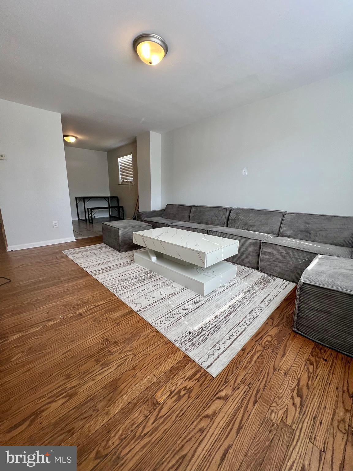 7201 Devon Street, Unit 1 Philadelphia, PA 19119 - Photo 6 of 13 a view of living room filled with furniture and wooden floor