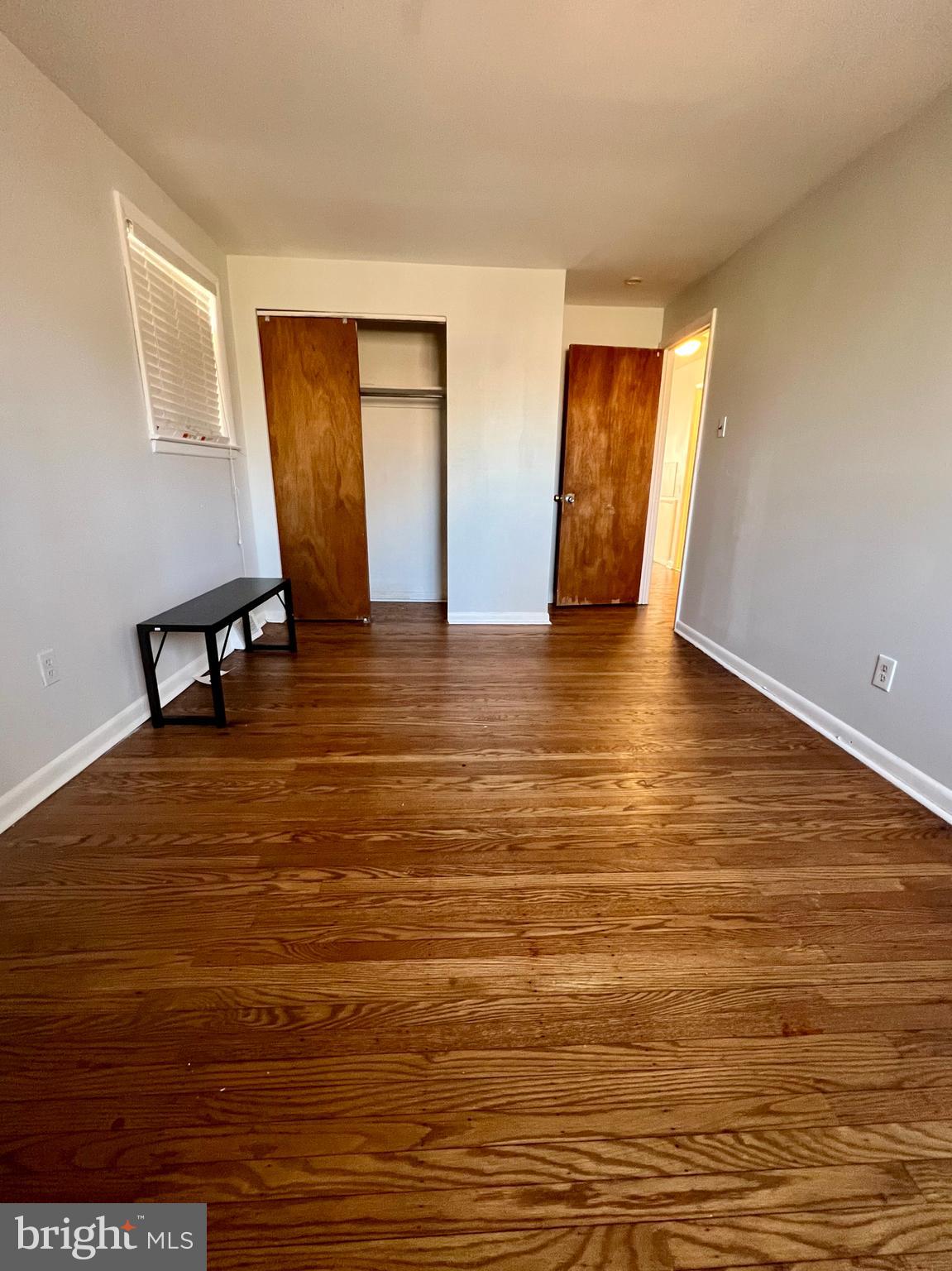 7201 Devon Street, Unit 1 Philadelphia, PA 19119 - Photo 9 of 13 a view of empty room with window and wooden floor