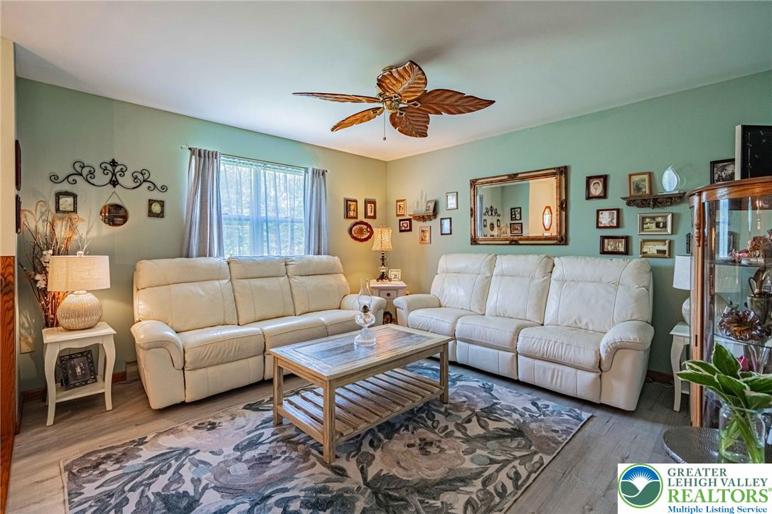341 Lower Greenhill Road Kunkletown, PA 18058 - Photo 9 of 69 Relax in this comfortable living room featuring elegant flooring and natural illumination.
