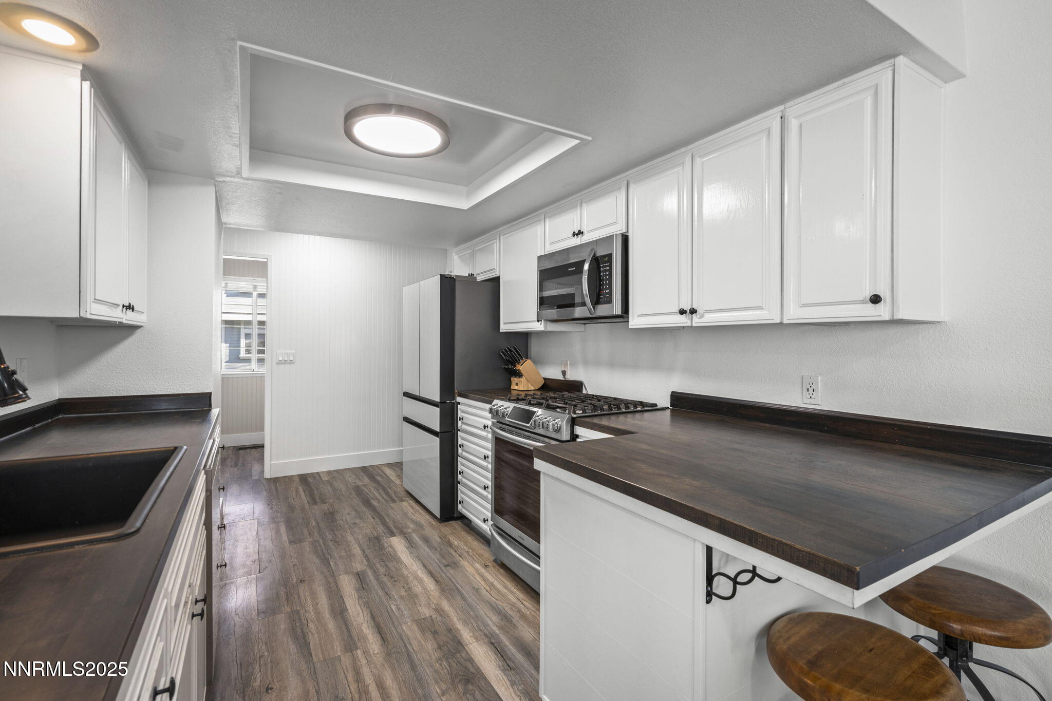1911 East Minaret Circle Reno, NV 89523 - Photo 8 of 27 a kitchen with granite countertop a stove sink and cabinets