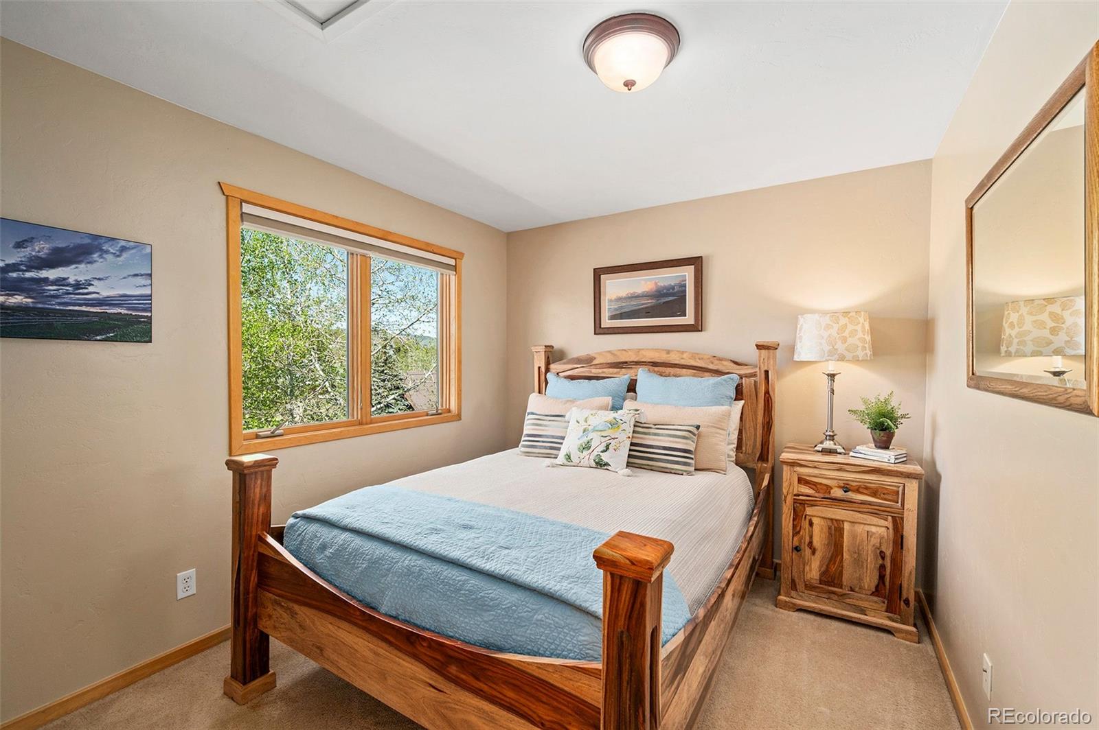 290 Village Road Granby, CO 80446 - Photo 21 of 45 a bed sitting in a bedroom next to a window