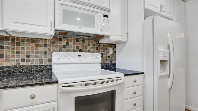 a stove top oven sitting inside of a kitchen