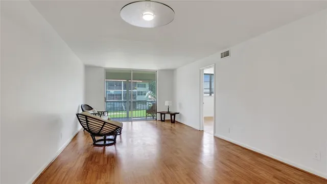 a view of workspace room with wooden floor and lounge chair