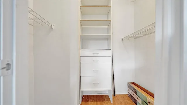 a view of walk in closet with empty racks