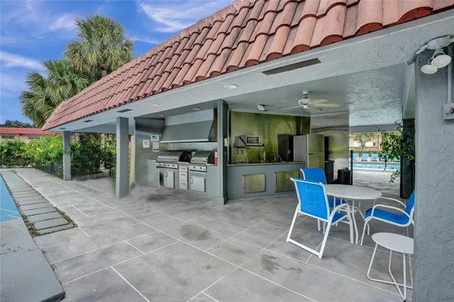 a view of a dining room with furniture and kitchen view