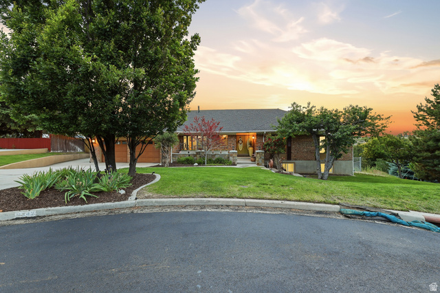 2342 Charros Road Sandy, UT 84092 - Photo 69 of 94 Brick exterior with a gabled roof and an inviting front entrance