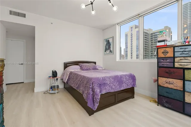 a bedroom with a bed and a dresser