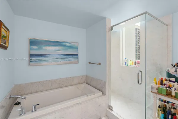a bathroom with a bathtub and a shower