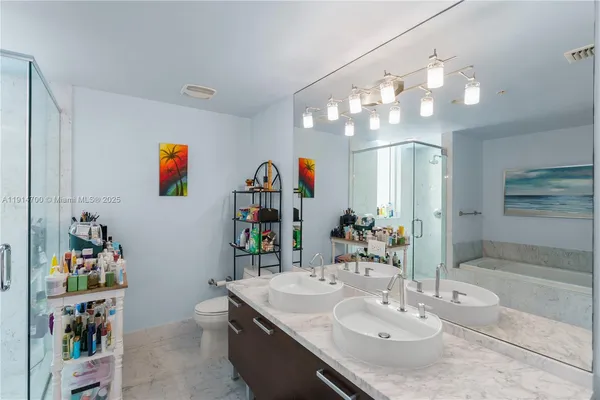 a bathroom with a sink a mirror and a shower