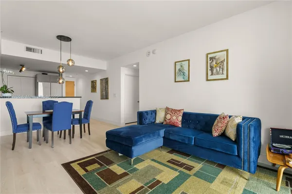 a living room with lots of furniture and a rug